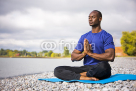 Fototapety young man exercising yoga
