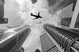 Air plane flying over the high buildings in central business dis
