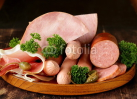 Fototapety various kinds of sausages and smoked bacon on the wooden plate