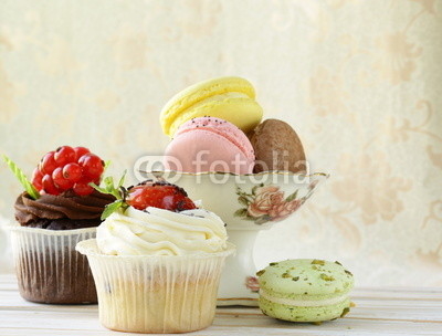 holiday desserts, cupcakes and macaroons on a vintage background