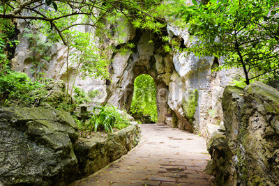Scenic stone walkway leading to gate in rocks