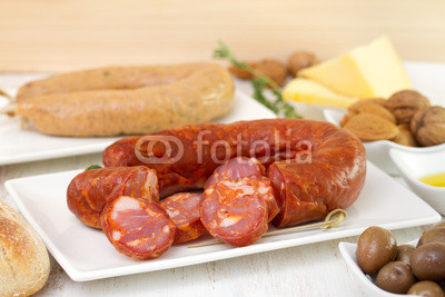 chorizo on dish with cheese and olives