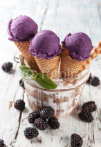 Naklejki Blueberry fresh ice cream scoops in cones on wood