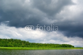 Fototapety Moody sky over lake.