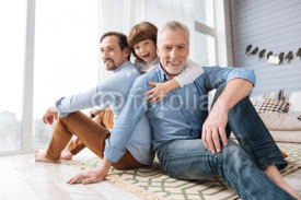 Handsome cheerful men sitting on the floor