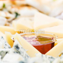 Obrazy i plakaty Cheese appetizer with honey macro. Dor Blue Cheese plate with  h