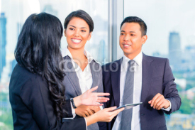 Asian Businesspeople standing in office