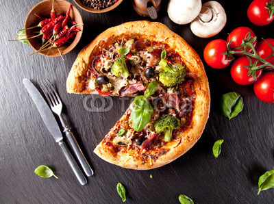 Fresh italian pizza served on black stone