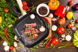 Fototapety Slices of Rare Beef in Pan with Fresh Ingredients