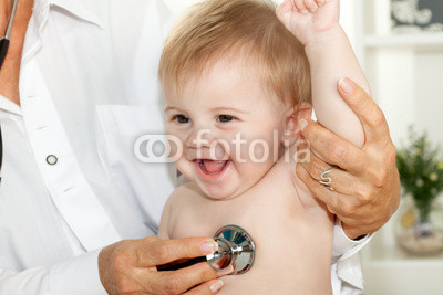 Happy baby at doctor with stethoscope