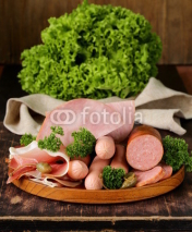 Fototapety various kinds of sausages and smoked bacon on the wooden plate