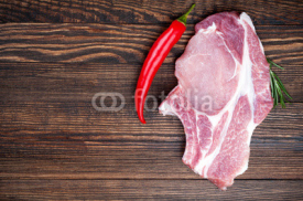 Fototapety Raw fresh meat ribeye steak with herb rosemary and pepper on a dark wooden background. Food background with pork steak