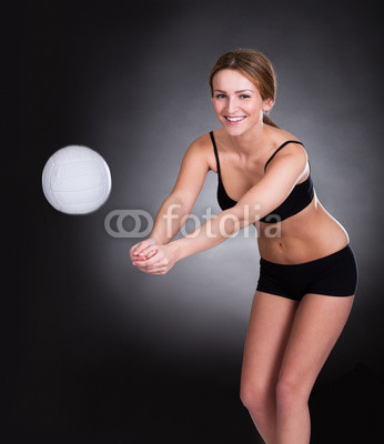 Young Woman Playing Volleyball