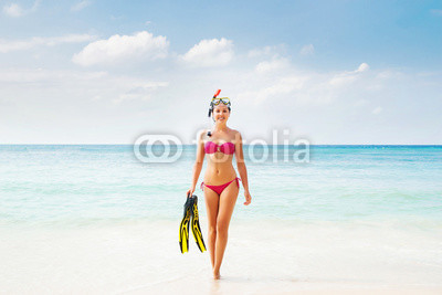 Beautiful, smiling girl in pink bikini diving in the sea