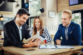 Small group of young people at a business meeting in a cafe