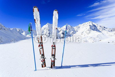 Ski, winter season, mountains and ski equipments on ski run