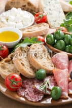 Obrazy i plakaty assorted Italian antipasti - deli meats, fresh cheese, olives