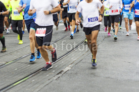 Fototapety Marathon runners race in city streets, blurred motion