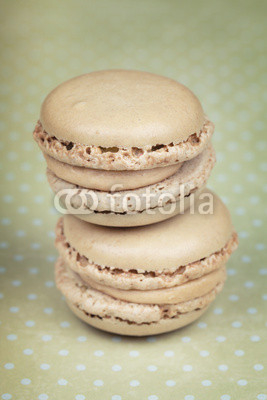 Two macaroons on green polka dots background