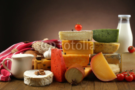 Fototapety Tasty dairy products on wooden table, on dark background