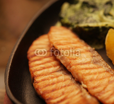 salmon steak served with spinach