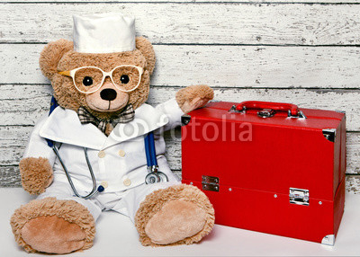 Teddy bear in medical clothing with the suitcase doctor