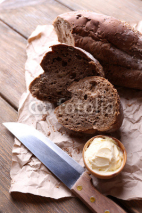 Fototapety Fresh bread and homemade butter on wooden background