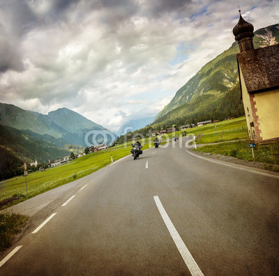 Biker race across mountainous village