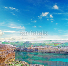rocky shore with clouds