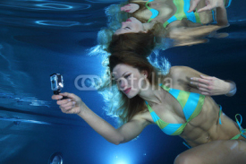 Naklejki Female swimmer with camera