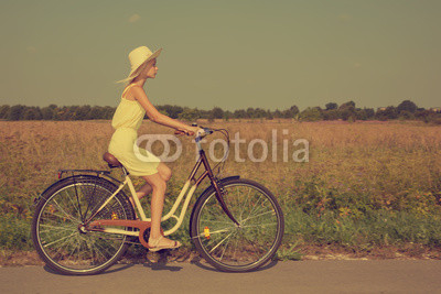 Young girl riding a bike.