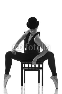 pretty young ballerina sitting on the chair.