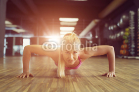 Fototapety Strong and beautiful athletic woman training in the gym
