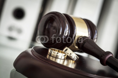 Divorce concept with gavel and wedding rings