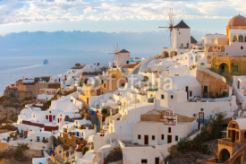 Picturesque famous view, Old Town of Oia or Ia on the island Santorini, white houses and windmills at sunset, Greece