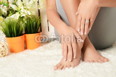 Female hands and feet with manicure and a pedicure
