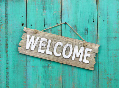 Welcome sign hanging on rustic background