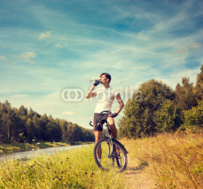 Naklejki Man Riding a Bicycle on Nature Background