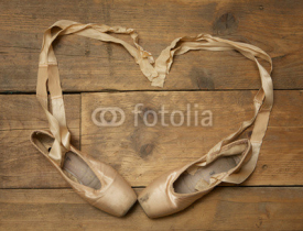 Naklejki Pair of Ballet Shoes on Wooden Floor