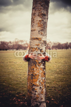 Naklejki Woman hugging a tree