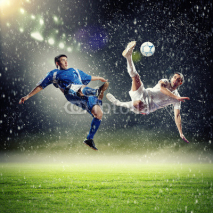 Obrazy i plakaty two football players striking the ball