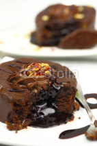 Naklejki Chocolate dessert with melted chocolate running from inside