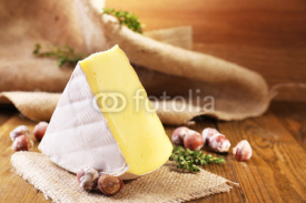 Fototapety Tasty Camembert cheese with thyme and nuts, on wooden table