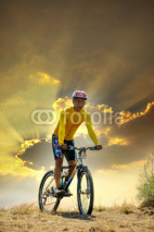 Naklejki young man riding moutain bike mtb on land dune