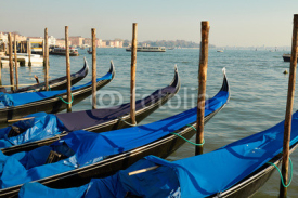 Naklejki Venice gondolas pier with blue gondola in Italia