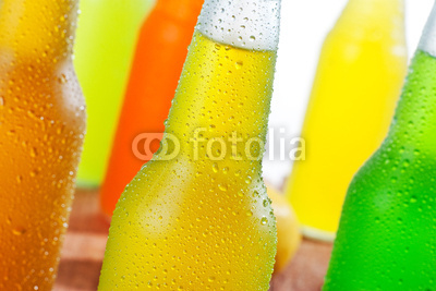 A lot of cold beverages in wet glass bottles