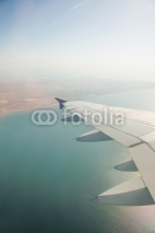 Fototapety Airplane wing out of window