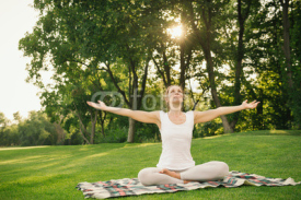 Woman meditating in the city park
