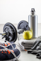 to work out with dumbbells, aluminum flask and healthy apple