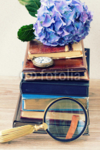 Fototapety pile of old books with flowers and clock